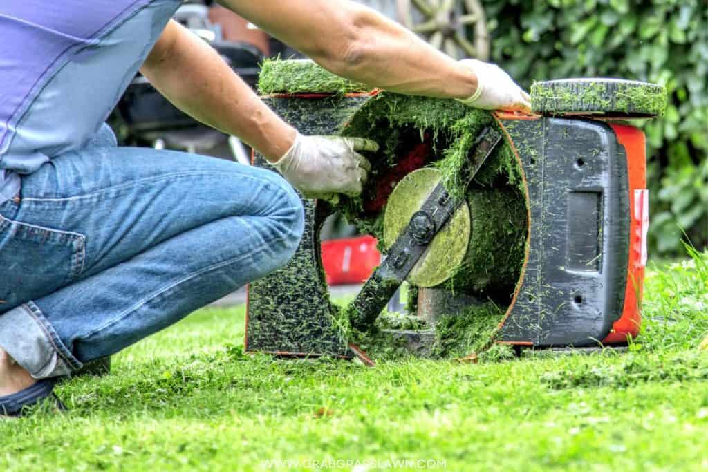 man balancing lawnmower blades